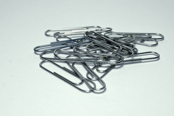 set of metal clips on white background - school supplies