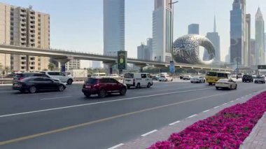 Dubai 'deki Şeyh Zayed Yolu' nun yoğun trafik manzarası. Arka planda Metro hattı ve Geleceğin Müzesi var. Dinamik şehir hayatı, şehir hareketi ve şehir büyümesi. 11 Şubat 2024, Dubai, BAE