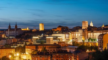 Teruel, İspanya 'nın panoramik gece manzarası, aydınlatılmış tarihi binalar ve şehir manzarası.