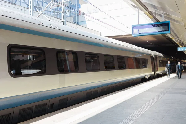 Fast modern passenger train on railway platform. Traveling concept background.