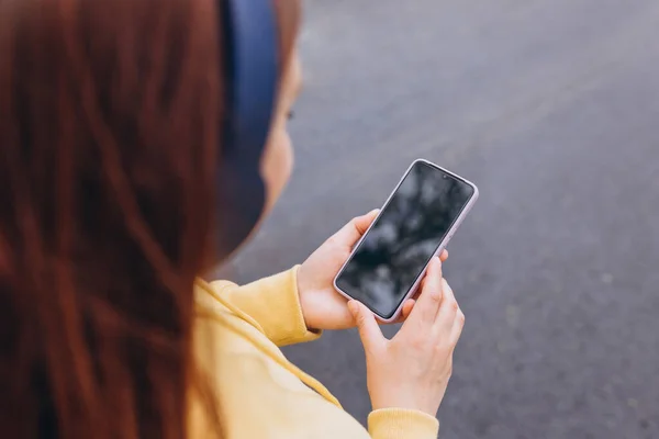 stock image Woman listening music on earphones in the morning. Close-up image of hands using smartphone, searching or social networks concept, hipster typing a message. For Graphic display montage