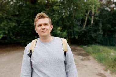 Yalnız otuzlu yaşlardaki adam, yalnızlık, depresyon, düşünceli adam. Sırt çantalı erkek hippi gezgin. Aktif yürüyüş kıyafeti giymiş bir adam kırsalda yürüyor.