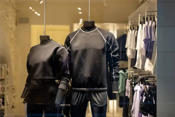 Mannequins in sport athletics suits in mall. Group of two mannequins in a store, close-up. Consumerism, shopping, special offer banner