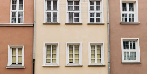 The facade of house with windows. Windows of an old typical apartment building made of panels