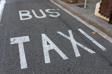 Bus and taxi lane in city. Large White Sign Shared Bus and taxi lane at Street clipart