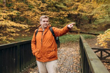 Sırt çantası açık havada gezen sarışın erkek. Ormanda yürüyüş yapıyor. Aktif yaşam tarzı konsepti. Trip, seyahat ve insanların afişi. Yüksek kalite fotoğraf