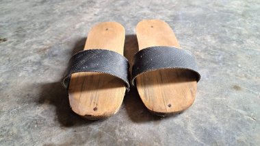 Authentic Indonesian Wooden Slippers  Traditional Javanese Bakiak with Rubber Straps, Unique Rural Footwear Representing Vintage Culture and Old-Time Simplicity clipart