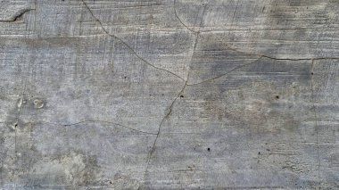 Eski grunge beton yüzey eskimiş çimento dokusu ve kaba taş desenleri, endüstriyel arka planlar için ideal.