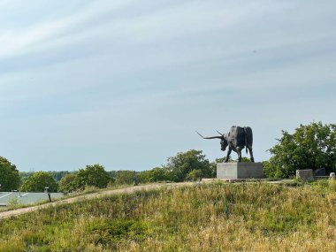 RAKVERE, ESTONIA - JUL 17, 2024: Bronze tarvas statue of aurochs bull by Tauno Kangro. Behemoth bovine memorial to the lost species. Symbol of the town.  clipart