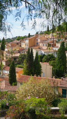 Panoramic view of houses and roofs of medieval village of Bormes-les-Mimosas, in the Var, in Provence, France clipart