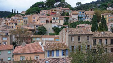 Panoramic view of houses and roofs of medieval village of Bormes-les-Mimosas, in the Var, in Provence, France clipart