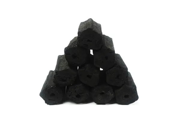 stock image pile of hexagonal charcoal briquettes isolated on a white background