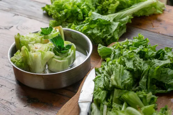 stock image regrow lettuce by putting lettuce head on a bowl fill with water, concept of growing your food and zero waste