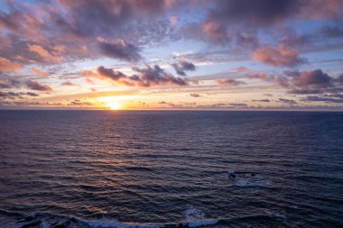 Engebeli volkanik kıyı şeridinde alacakaranlık renkleri ve Fuerteventura 'da La Pared yakınlarında sakin dalgalar.. 