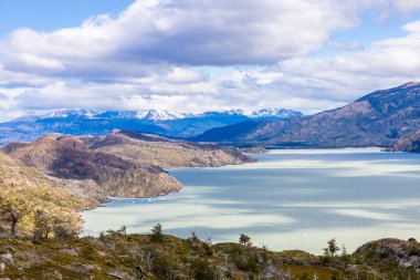 Torres del Paine dağları Şili 'deki Patagonya And Dağları ulusal parkı. Güney Amerika dağ manzarası. Güneşli bir günde, Los Cuernos, Torres del Paine ve Paine Grande göl kıyısında tepeler.