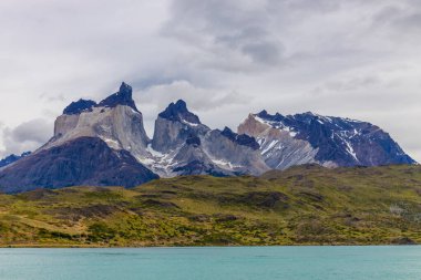 Torres del Paine dağları Şili 'deki Patagonya And Dağları ulusal parkı. Güney Amerika dağ manzarası. Güneşli bir günde, Los Cuernos, Torres del Paine ve Paine Grande göl kıyısında tepeler.
