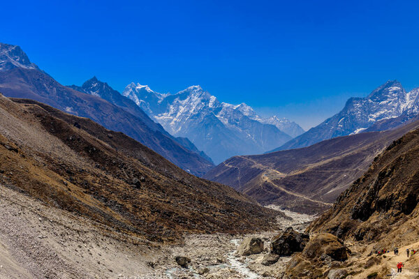 Himalaya mountains landscape with high altitude snow and ice glacier summit peaks. Everest Base Camp Solo Khumbu trekking region in Nepal. Beautiful Himalayas eight thouthander summits under blue sky