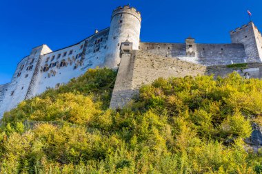Avusturya 'nın Salzburg şehrinde. Kiliseler, şato, köprü ve arkasında dağlar olan güzel şehir manzarası. Salzburg 'un ünlü şehirleri ve turistik yerleri.