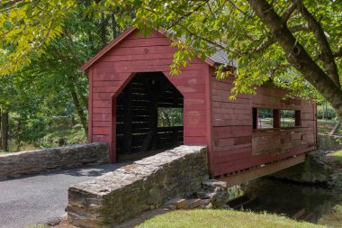 A photo of the Carroll Creek Covered Bridge in Frederick Maryland taken in the summer clipart