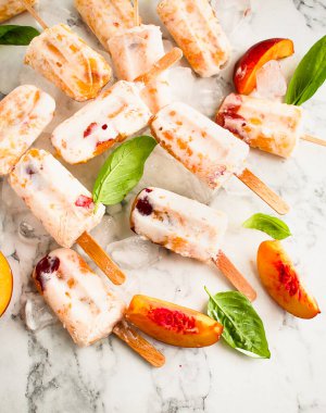 Yaz şeftalili yoğurt, beyaz arka planda bir tabakta patlıyor. Şeftalili ev yapımı buzlu dondurma. Yaz şeftalili yoğurt dondurması..