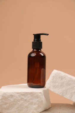 Bej arka planda kozmetik şişesi