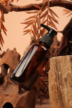 bottle of essential oil on wooden background