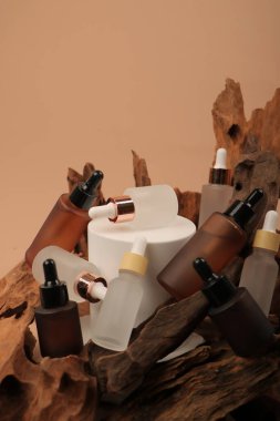 Bej ahşap arka planda doğal kozmetik ürünleri olan şişeler. Metin için boşluk
