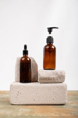 Banyo için şişe ve sabun beyaz duvardaki ahşap bir rafta.