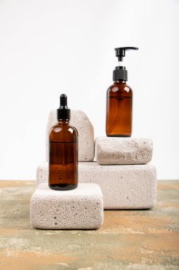 Beyaz arka planda doğal kozmetik ürünleri olan şişeler