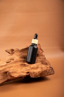 bottle of essential oil on wooden background
