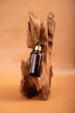 Kahverengi ahşap arka planda parfüm şişesi. Doğal parfüm şişesi.