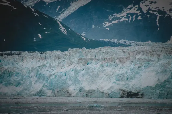 stock image A breathtaking close-up of a massive Alaskan glacier, showcasing the icy blue texture and the rugged terrain. Ideal for nature, adventure, and environmental themes in stock video and footage.