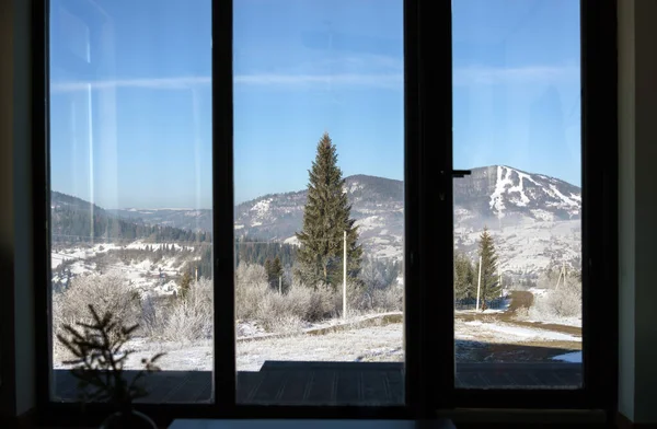Snowy Mountain view from big window in Ukraine