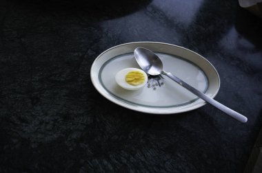 Kaşık ile beyaz bir tabakta yarım yumurta, Danimarka, 24 Nisan 2025