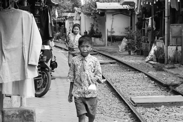 stock image life of urban communities living near the railroad tracks, children of workers, schools taken in Malang Add on June 6 2024