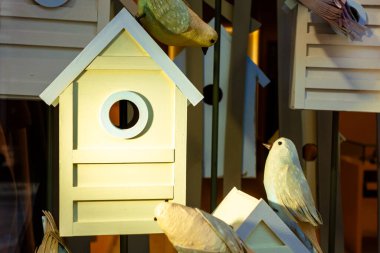 Decorative composition of birds in birdhouses.