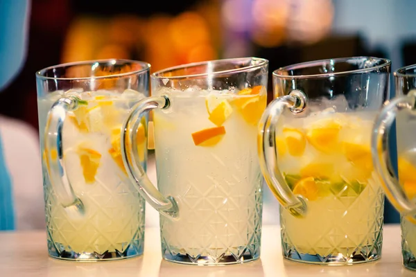 Glasses with white fruit lemonade.