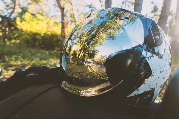 Helmet with a mirrored visor on a motorcycle