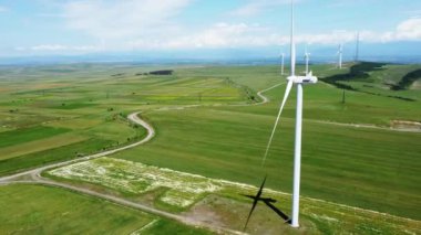 Yeşil çayırları zarif bir şekilde noktalayan yel değirmenlerinin büyüleyici hava görüntüsü yenilenebilir enerji kavramını somutlaştırıyor.
