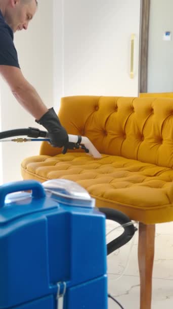 Man Performs Wet Cleaning Sofa Using Specialized Washing Vacuum Cleaner — Stock Video