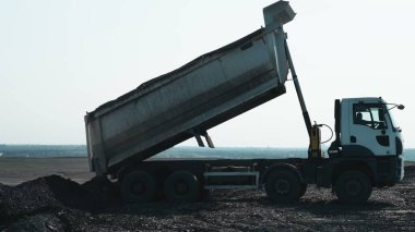 Yolda kömür ve kömür kamyonu var.