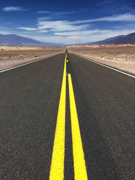 Stock image Death Valley in California, experiencing the dramatic desert landscape, vast salt flats, towering sand dunes, and extreme temperatures of this iconic and rugged terrain