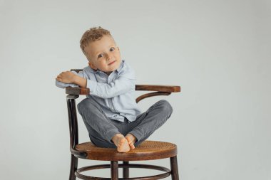 little boy, 4 years old, blond in a shirt