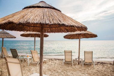 Beautiful tropical beach with white sand and palapa (thatched roof) in the Caribbean, Mexico. Summer beach background.