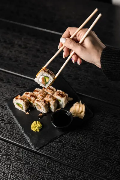 sushi food. Maki ands rolls with tuna, salmon, shrimp, crab and avocado. Top view of assorted sushi. Rainbow sushi roll, uramaki, hosomaki and nigiri.