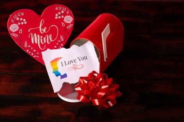 A red mailbox surrounded by heart-shaped decorations, perfect for Valentines Day.  clipart