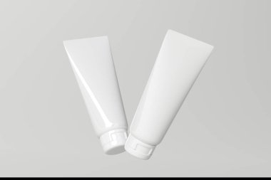 İki tüp losyon düşüyor, üstleri açık.