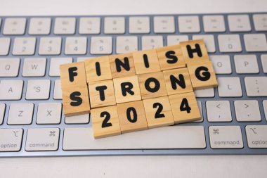 the wooden box says finish strong 2024 on top of keyboard clipart