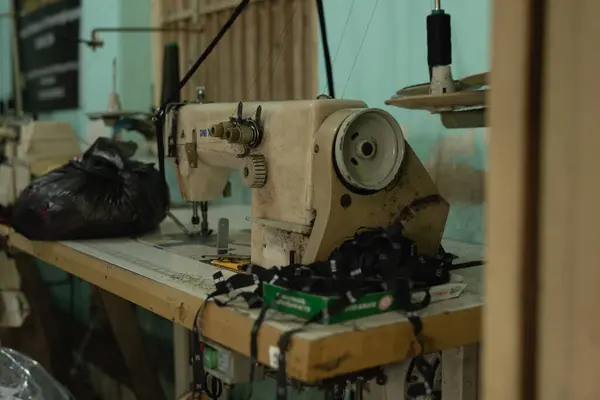 Dikiş makinesi bir çalışma tezgahında, antika dikiş makinesinde boş boş oturur.