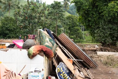 Damaged house with debris scattered around it. Flood disaster in Situbondo, East Java, Indonesia on February 5, 2025 clipart